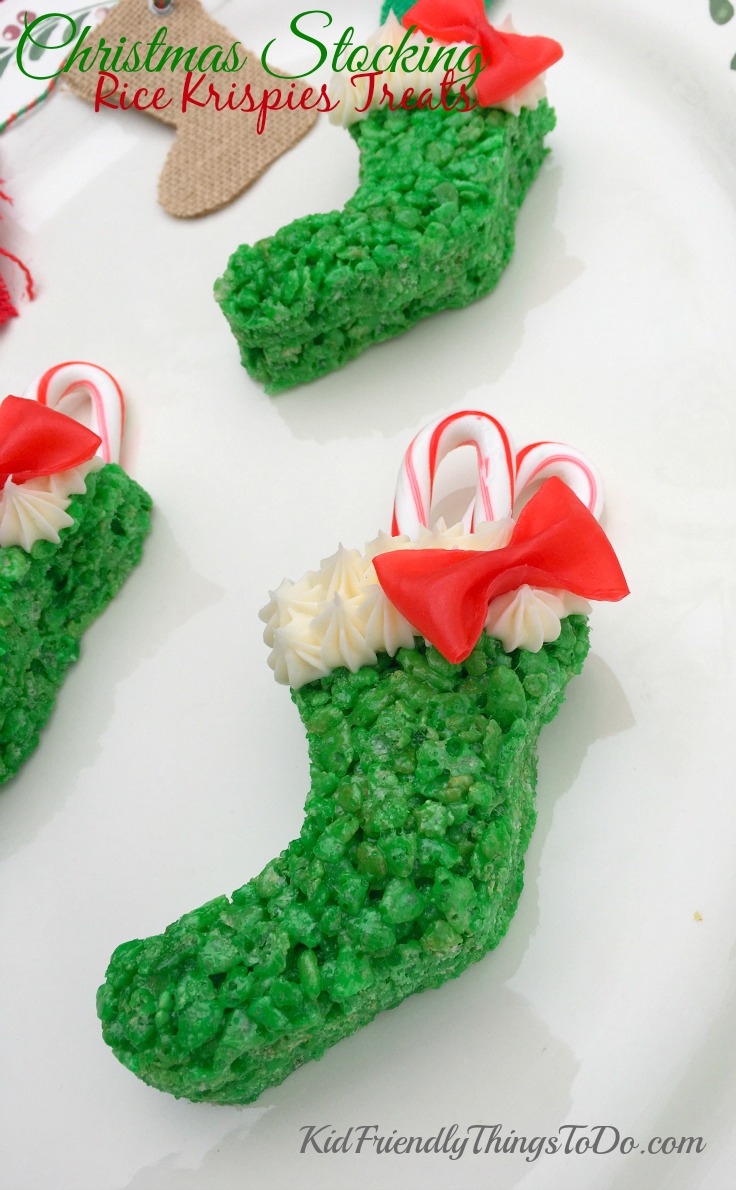 I love these! Christmas Stocking Rice Krispies Treats with easy Fruit Roll Up Bows, stuffed with candy canes! So awesome for a fun food at Christmas! - KidFriendlyThingsToDo.com