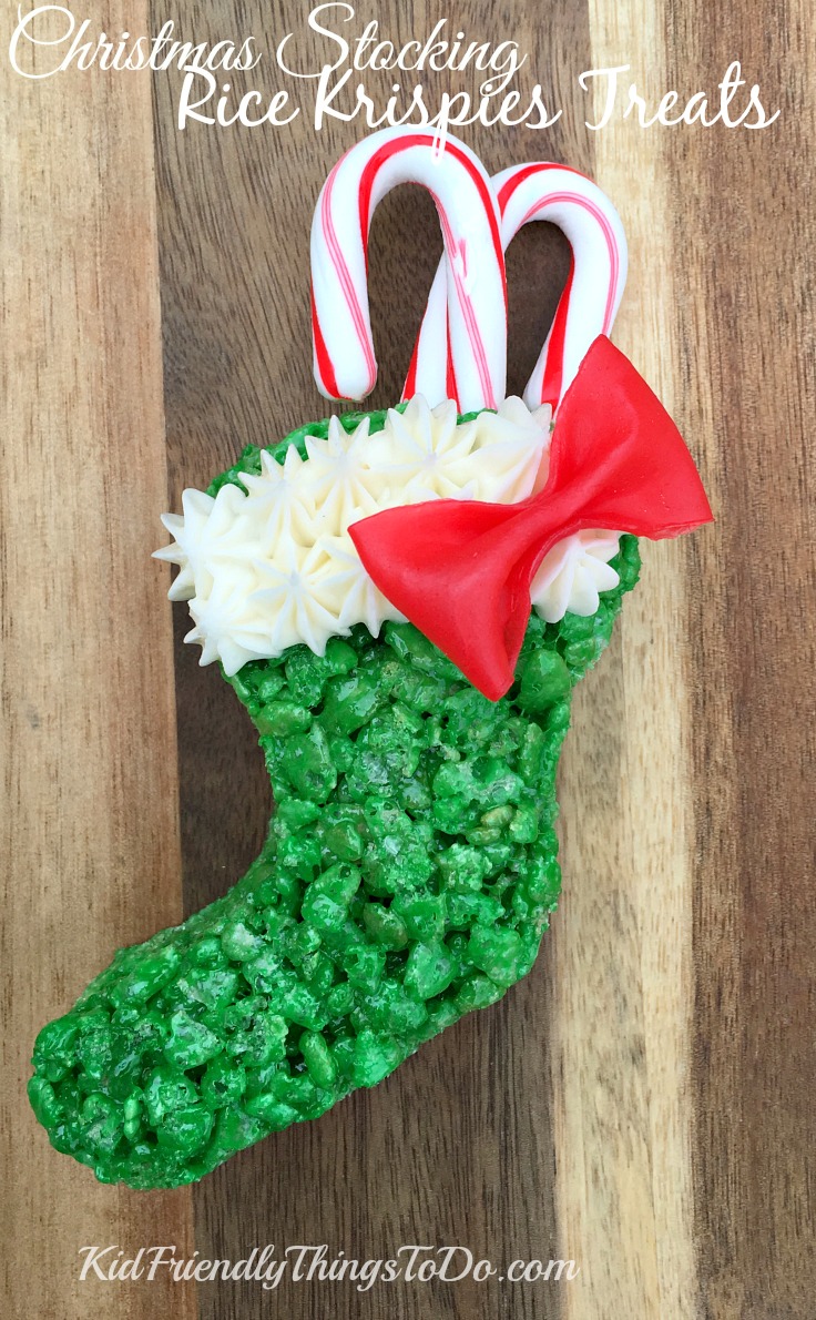 I love these! Christmas Stocking Rice Krispies Treats with easy Fruit Roll Up Bows, stuffed with candy canes! So awesome for a fun food at Christmas! - KidFriendlyThingsToDo.com