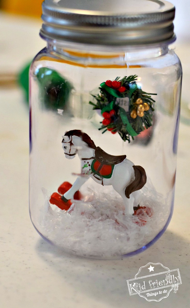 DIY Mason Jar Snow Globes for a Winter or Christmas Craft - OR - Christmas Ornament - Perfect for Christmas parties with kids! So much fun. - www.kidfriendlythingstodo.com