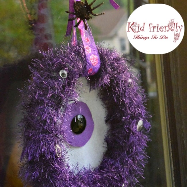 A DIY One-eyed Monster Wreath craft for Halloween - easy to make and so cute as a Halloween decoration - www.kidfriendlythingstodo.com