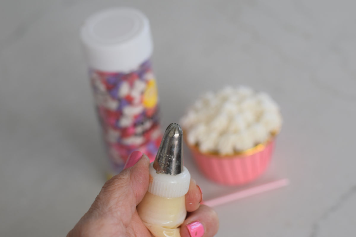 decorating a cupcake with a star tip 