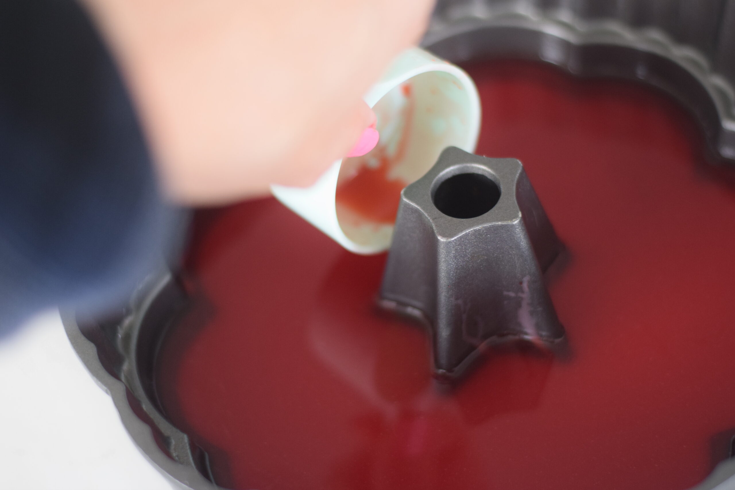 adding red Jell-O to mold 