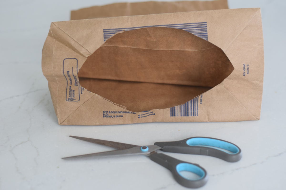 cutting hole in paper bag for head 