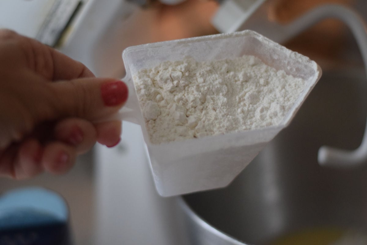 adding flour to mixer