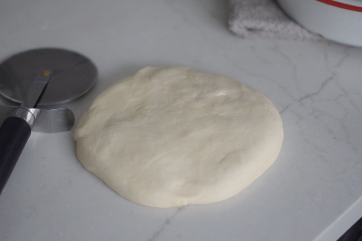 shaping dough into a circle 