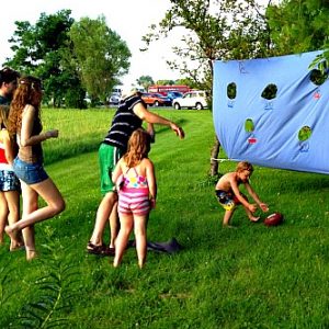 A Football Toss Game made from an old twin bed sheet! This is great for summer picnics, and birthday parties!