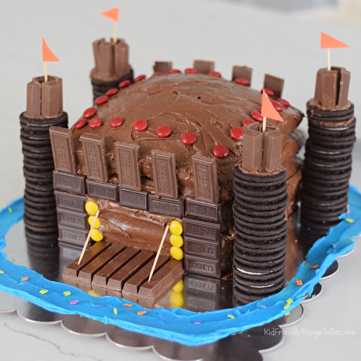 chocolate castle cake with candy and cookies for a kid's birthday party