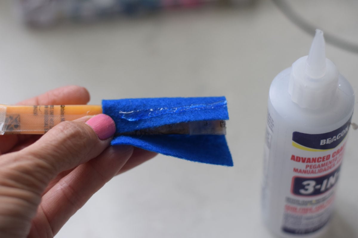 making Minion cheese sticks - gluing blue felt 