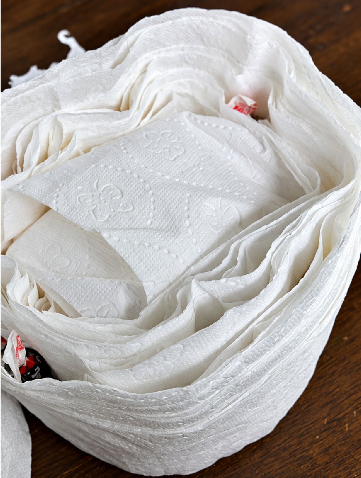 Partially unwrapped toilet paper mummy prize ball with wrapped candy tucked between the layers.