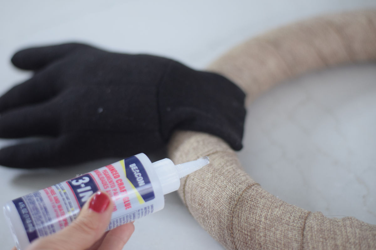 gluing antler gloves to wreath