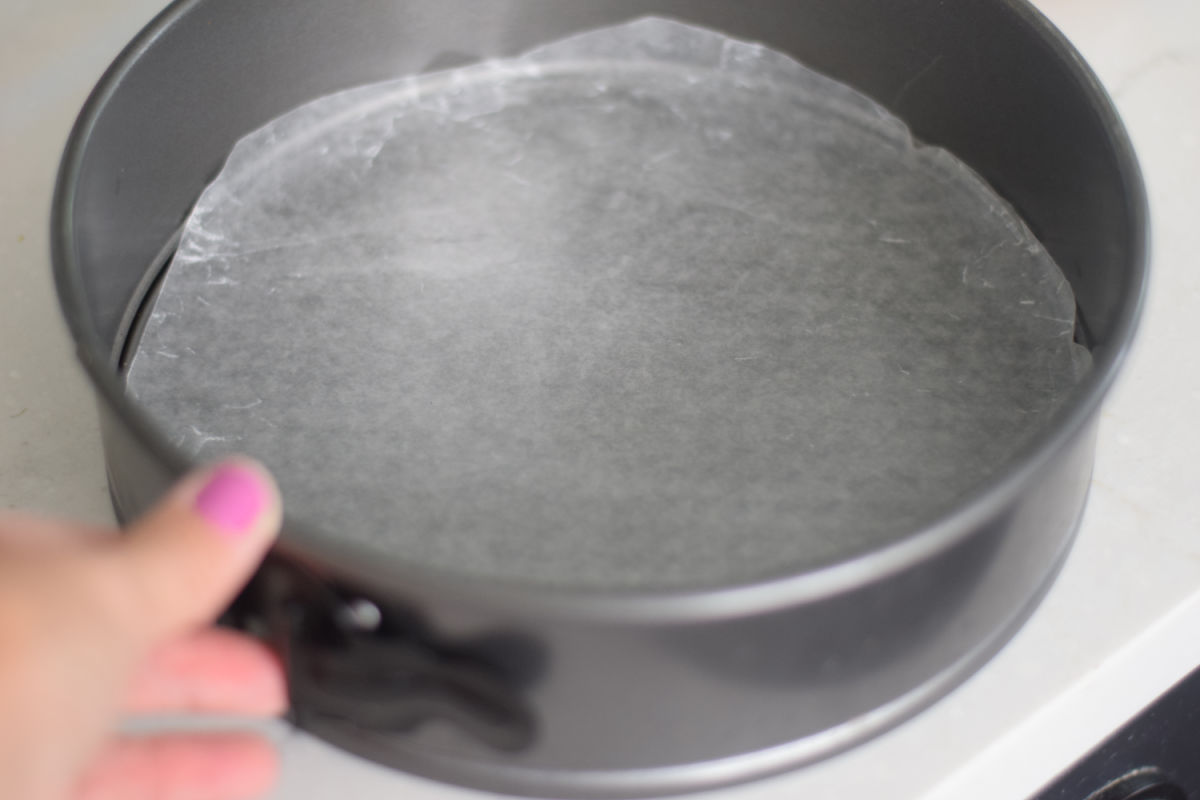 making ice cream cake by cutting wax paper  