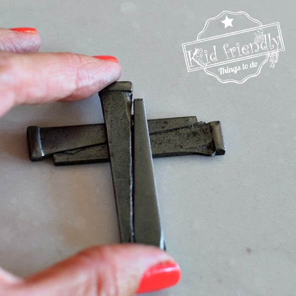Making a cross necklace out of nails 