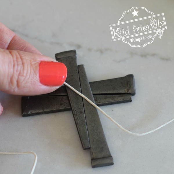 Making a cross necklace out of nails 
