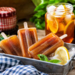 sweet tea popsicles in tray of ice with tea in the background