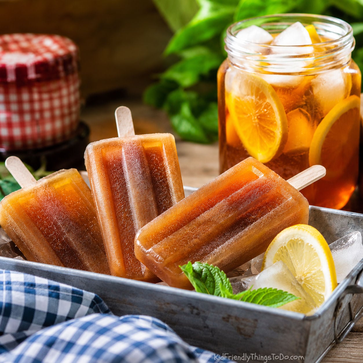 sweet tea popsicles in tray of ice with tea in the background