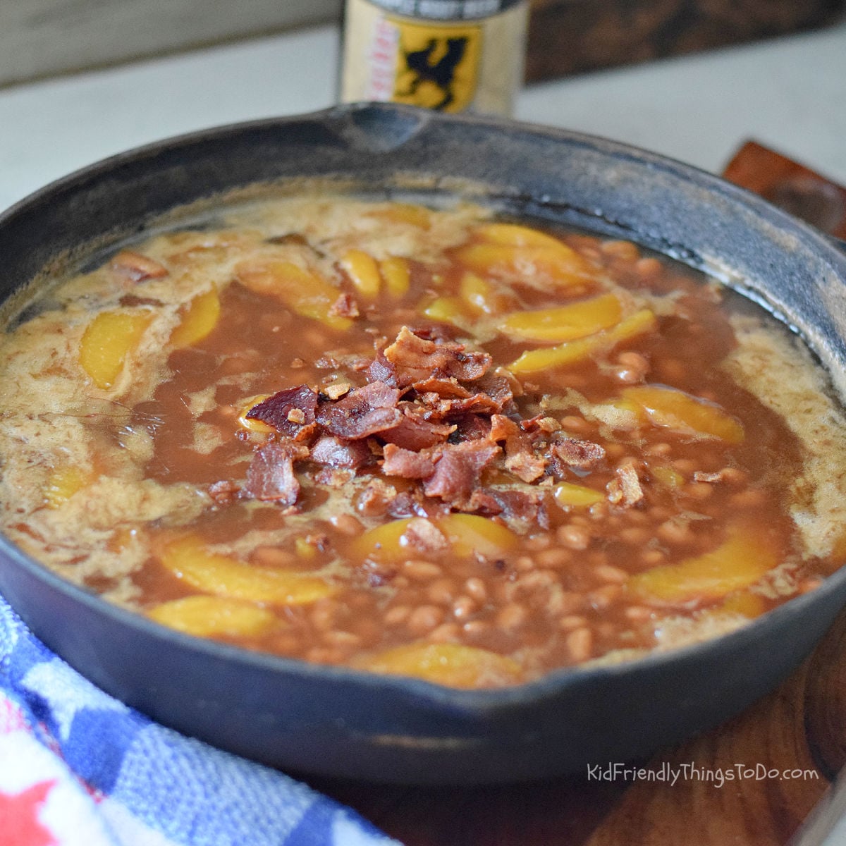 peach root beer baked beans with bacon in cast iron skillet campfire recipe