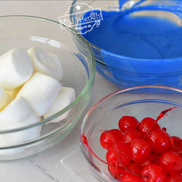 Bowls with marshmallows, chocolate and cherries 