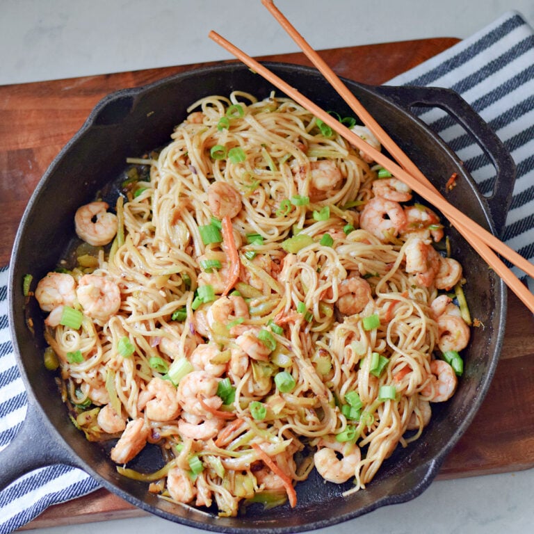 Shrimp lo mein with noodles and vegetables in a skillet.
