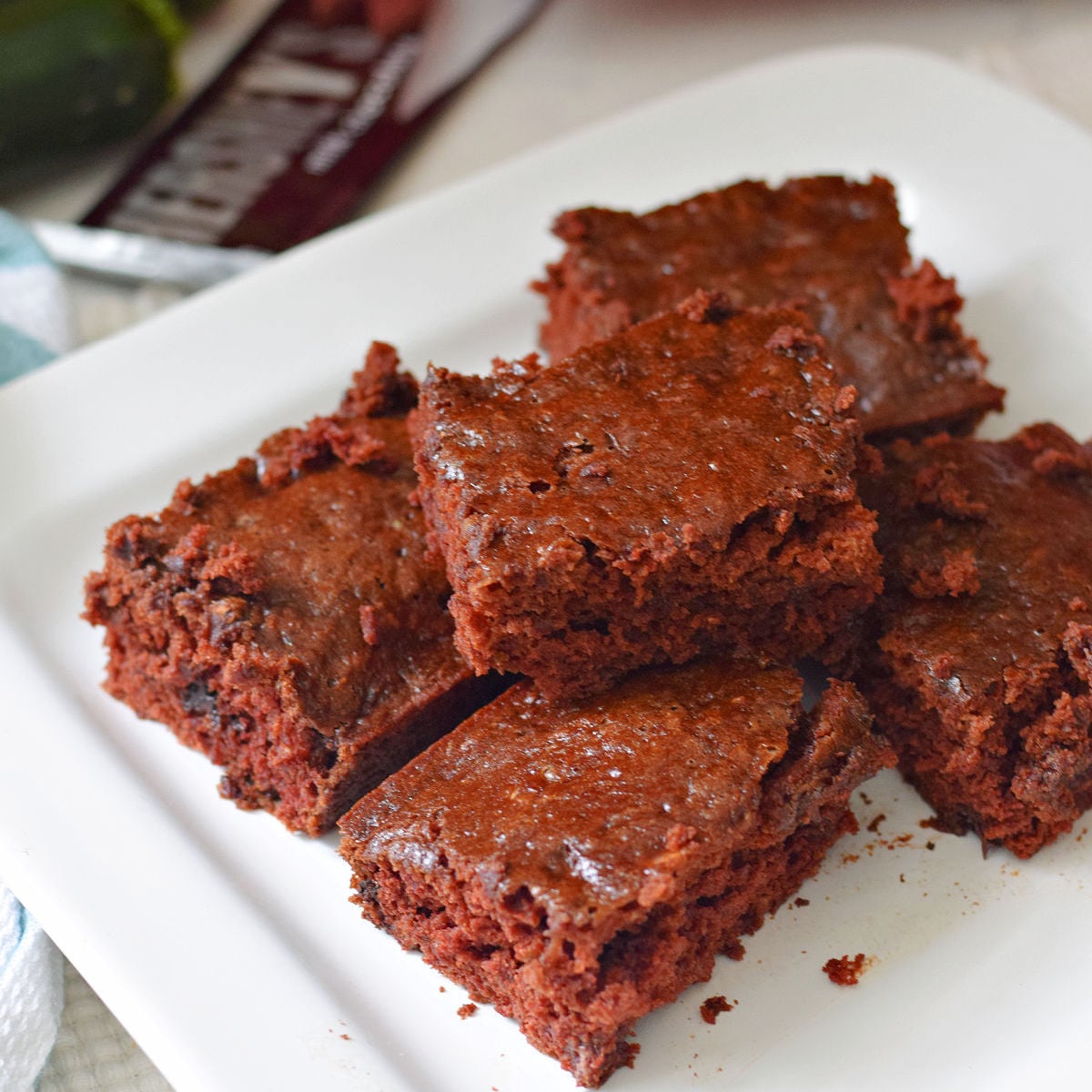 homemade zucchini brownies stacked on a platter