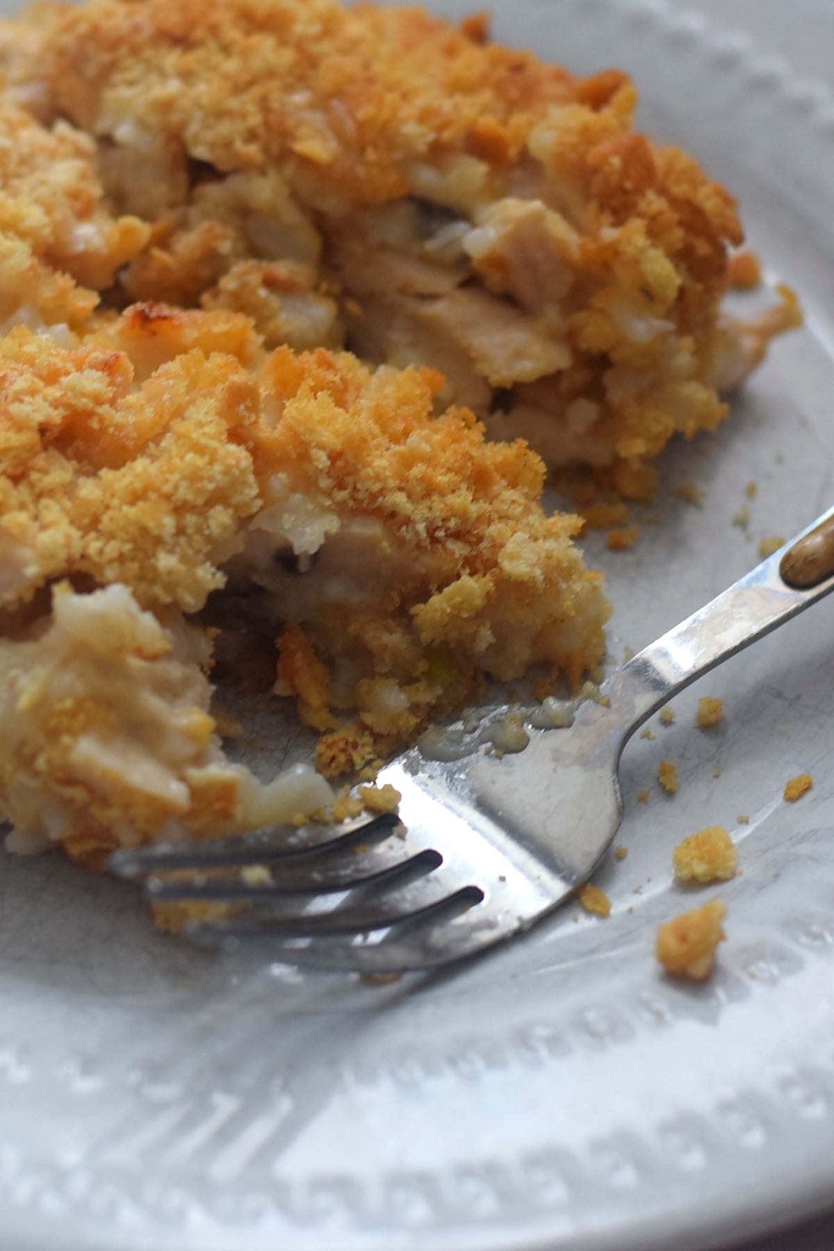 Plated serving of cheesy chicken and rice casserole with golden Ritz cracker topping with Ritz cracker topping