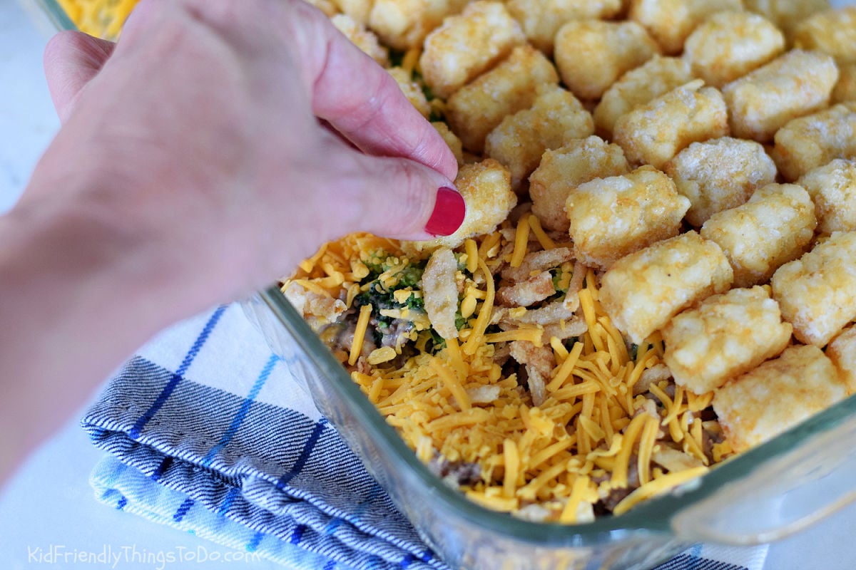 ground beef tater tot casserole assembly - adding tater tots