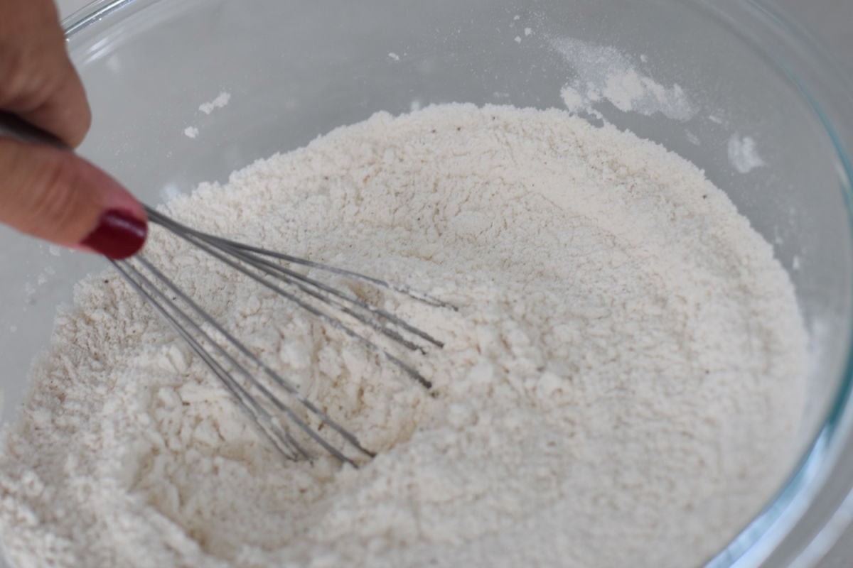 mixing flour in bowl for sugar cookies