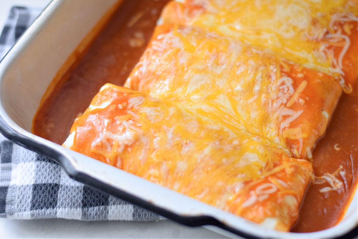 wet burritos with red sauce and cheese 