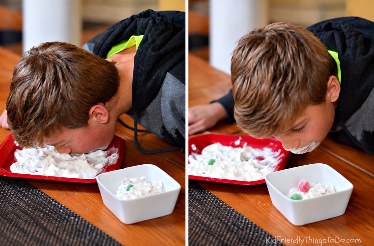 Boy playing Santa’s Beard Christmas Minute to Win It game by finding gumdrops hidden in whipped cream.