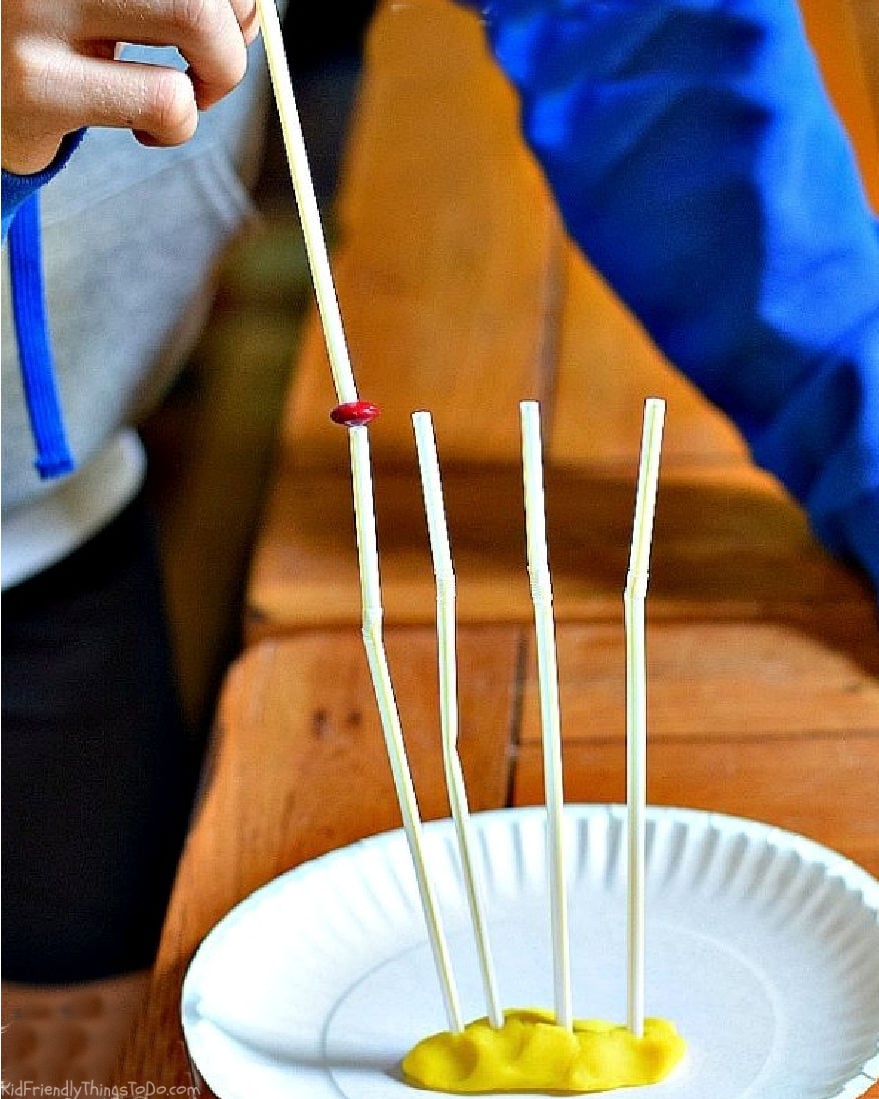 Suck It Up game variation balancing candy on upright straws