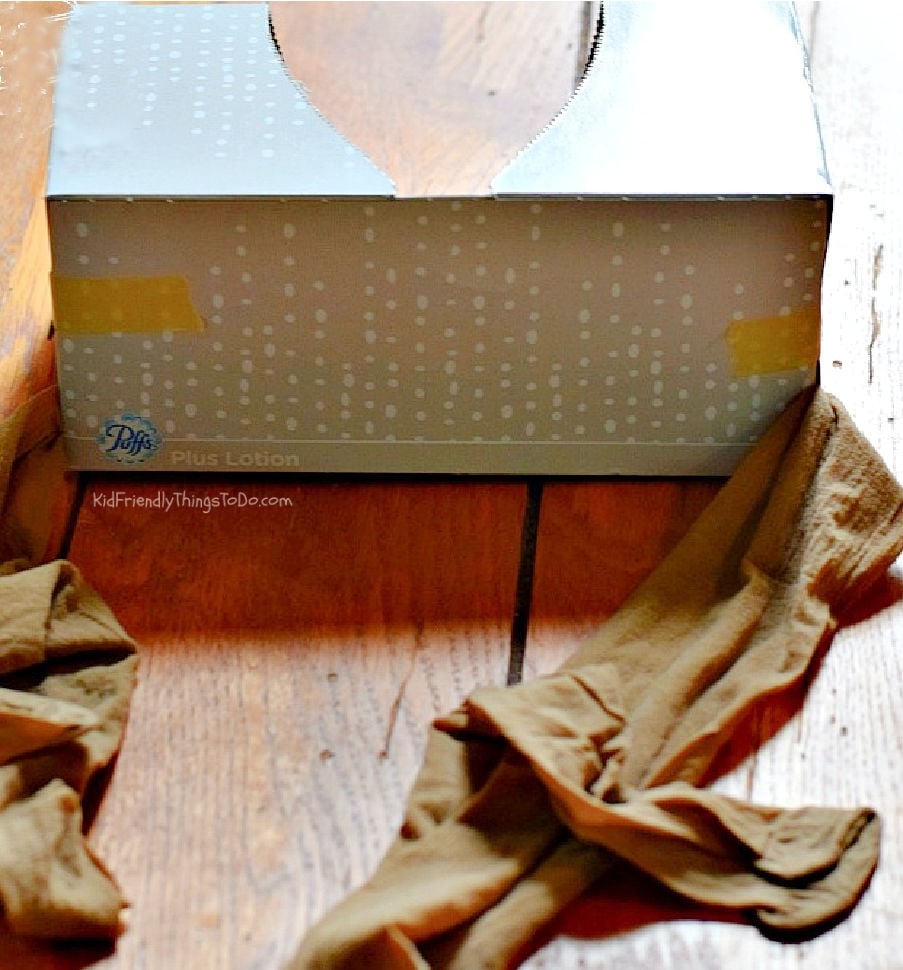 Tissue box and pantyhose setup for Shake Ya Tail Feather game