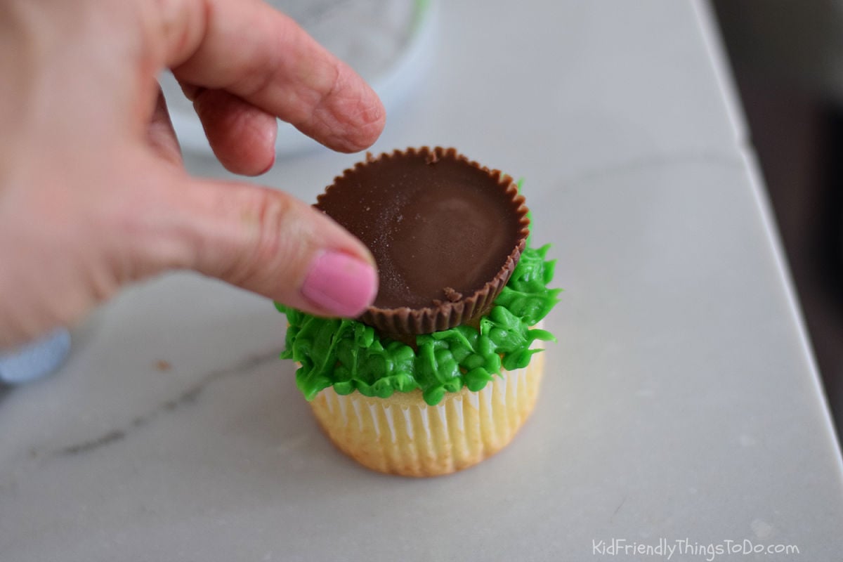 adding Reese's cup to bird nest cupcake 