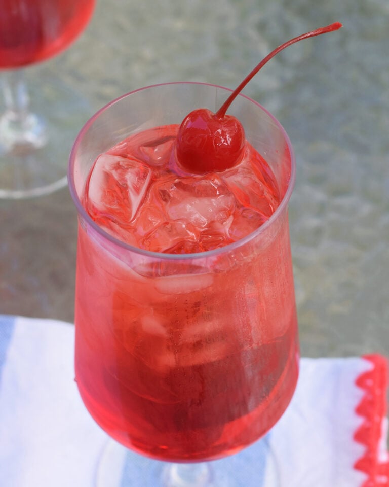 Classic Shirley Temple drink with ice and maraschino cherry