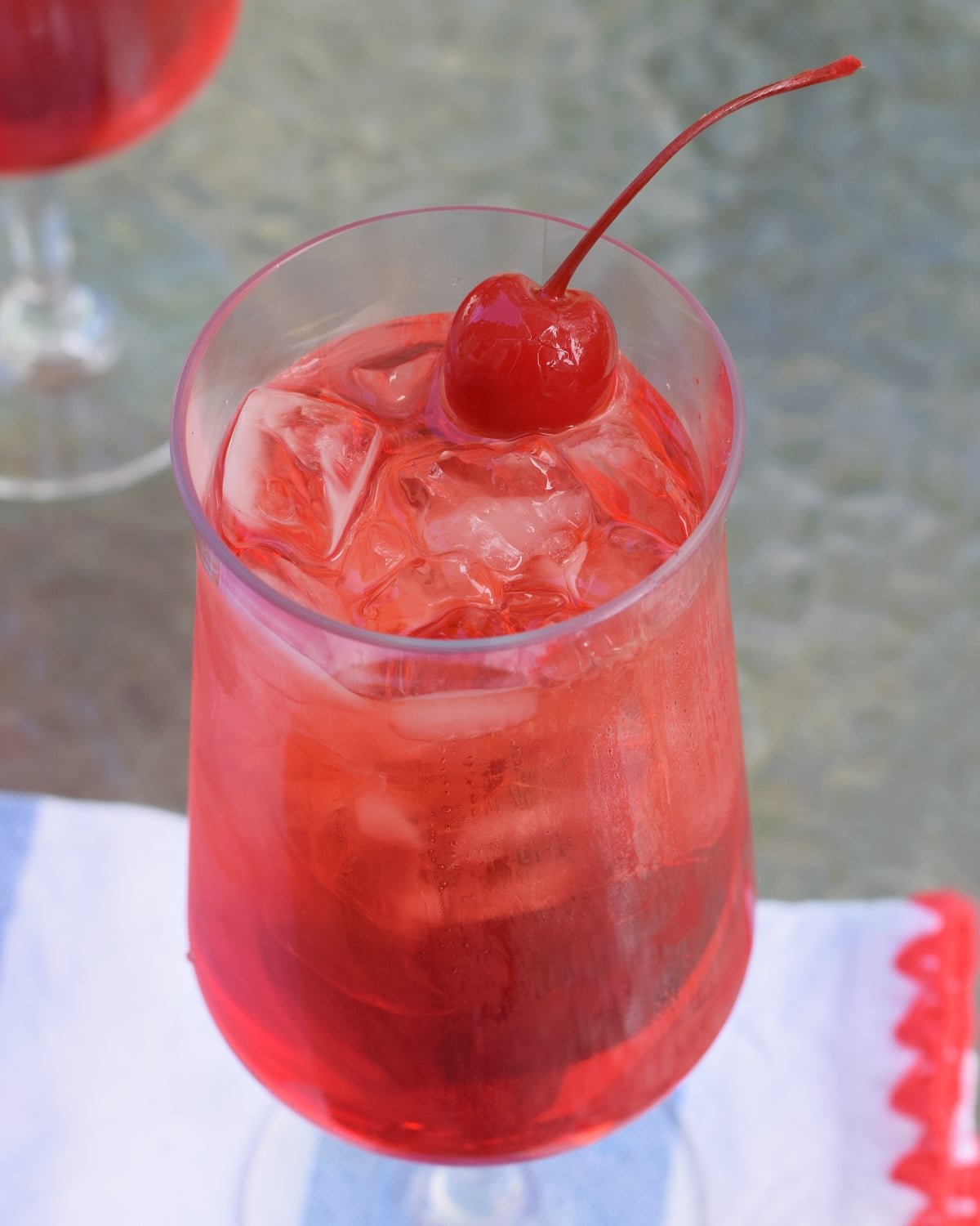 Classic Shirley Temple drink with ice and maraschino cherry