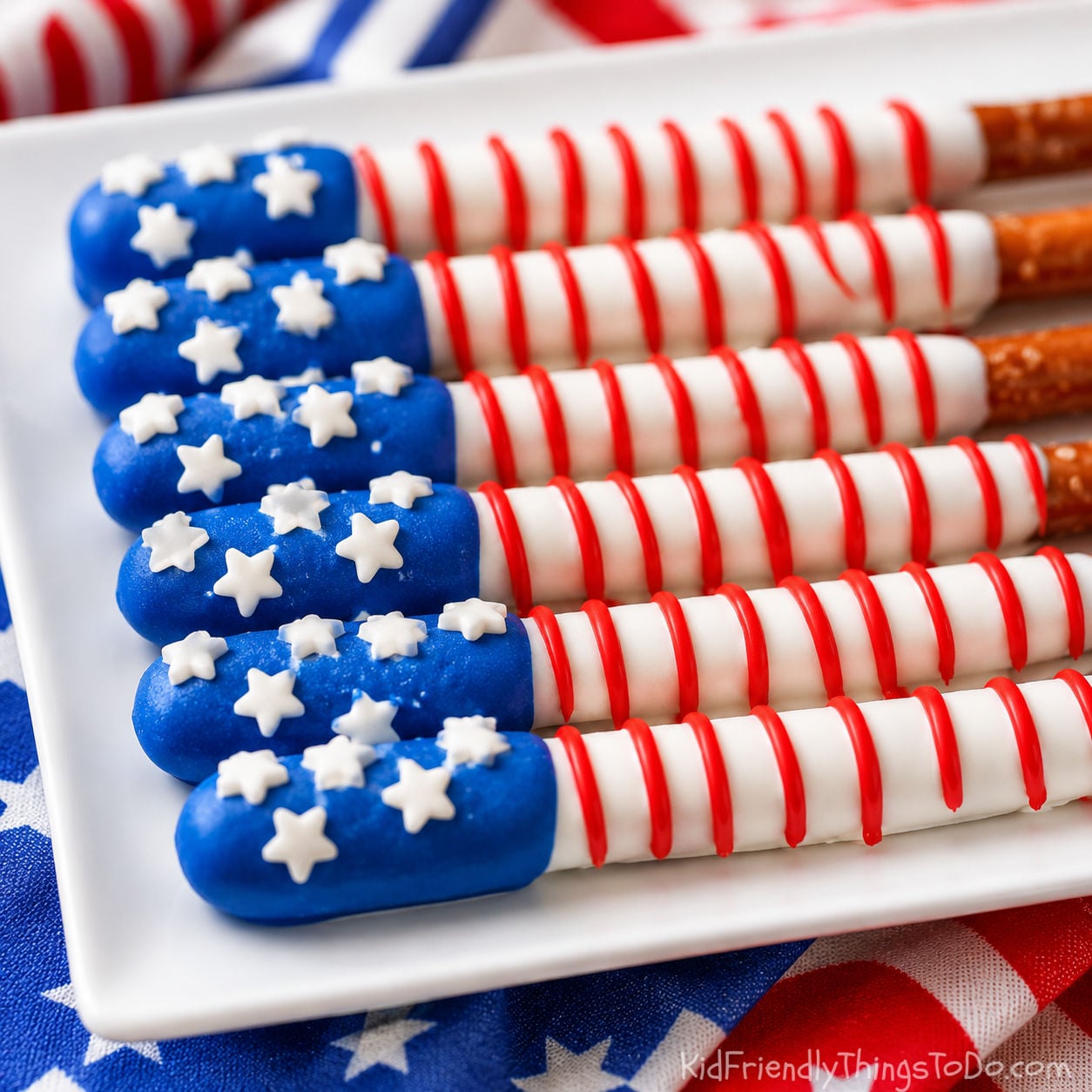 patriotic party treats chocolate dipped pretzel rods made to look like the American flag for fourth of July
