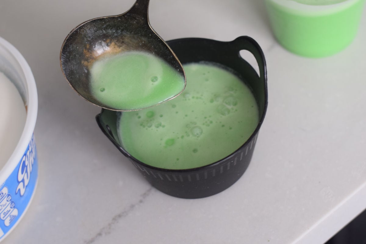 pouring Jell-O into mini cauldrons 