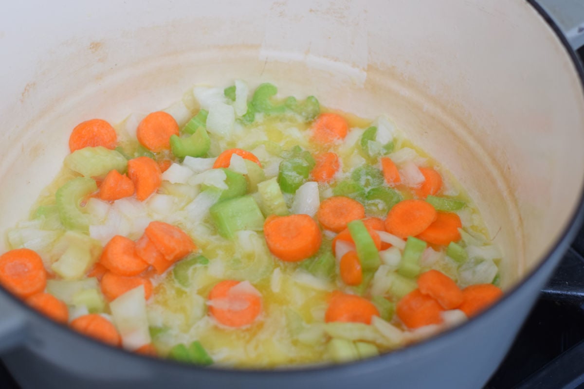 adding vegetables to crab chowder 