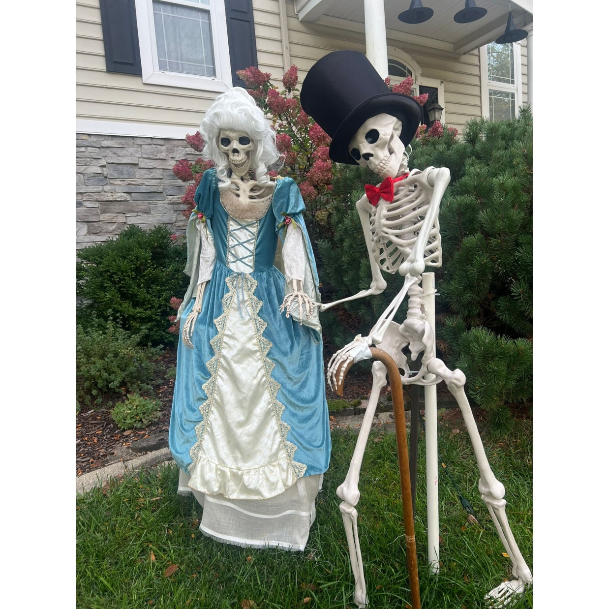 skeleton display in yard attending a ball with top hat and dress 