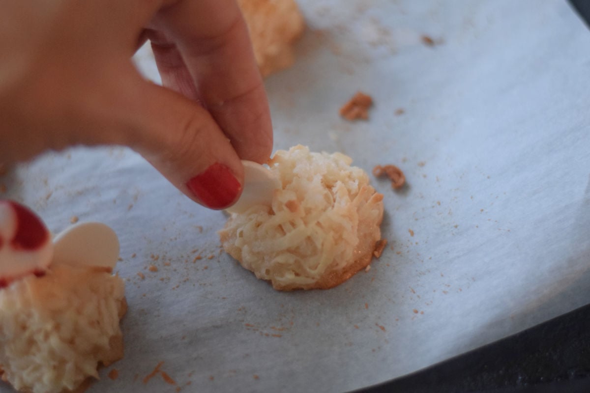 adding chocolate melts to coconut macaroons