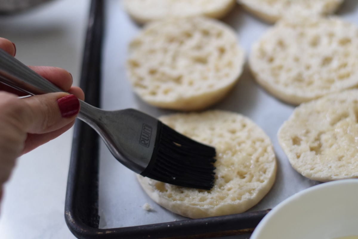 brushing olive oil and English Muffins 