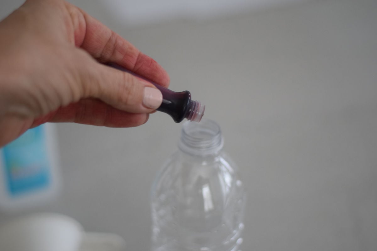 adding food coloring to homemade thermometer 