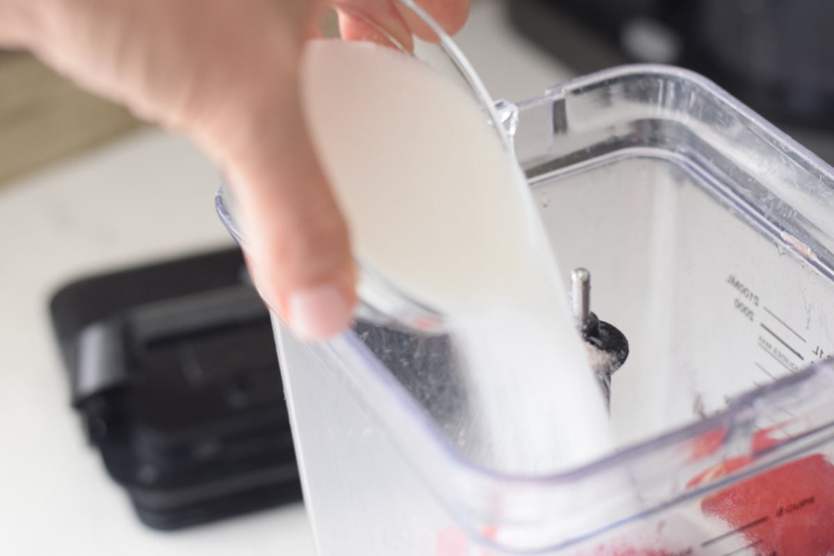 adding sugar to blender