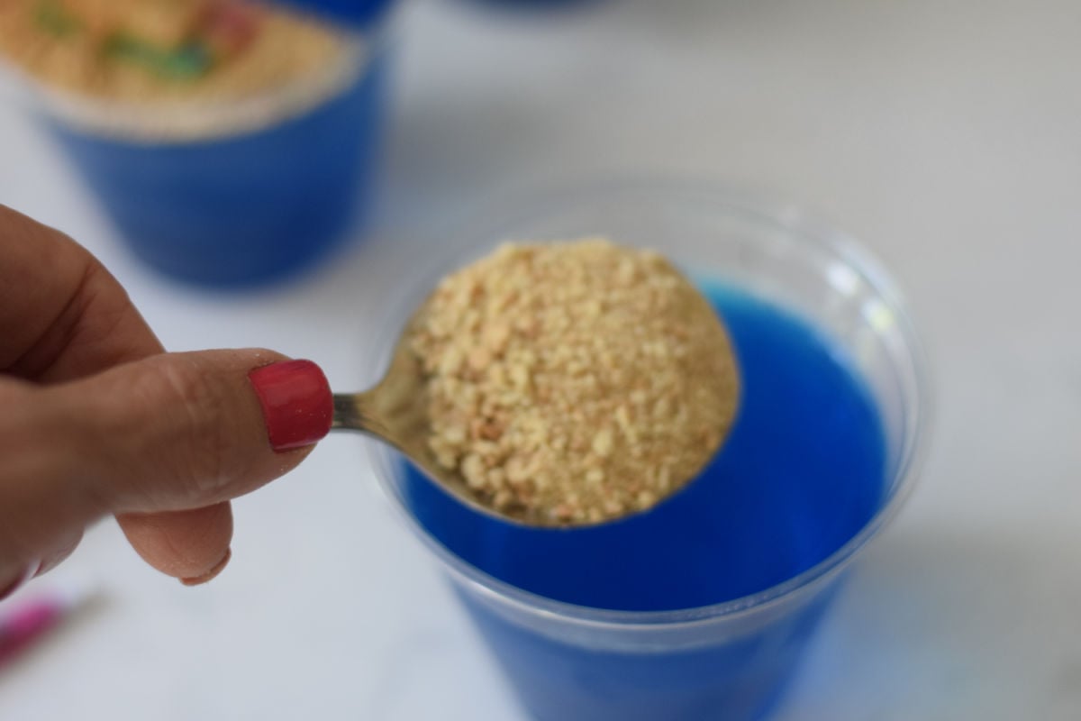 pouring graham cracker onto Jello