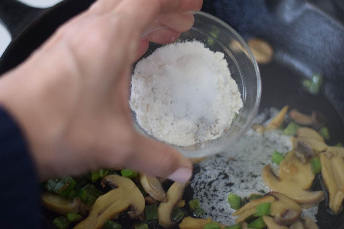 adding flour to skillet