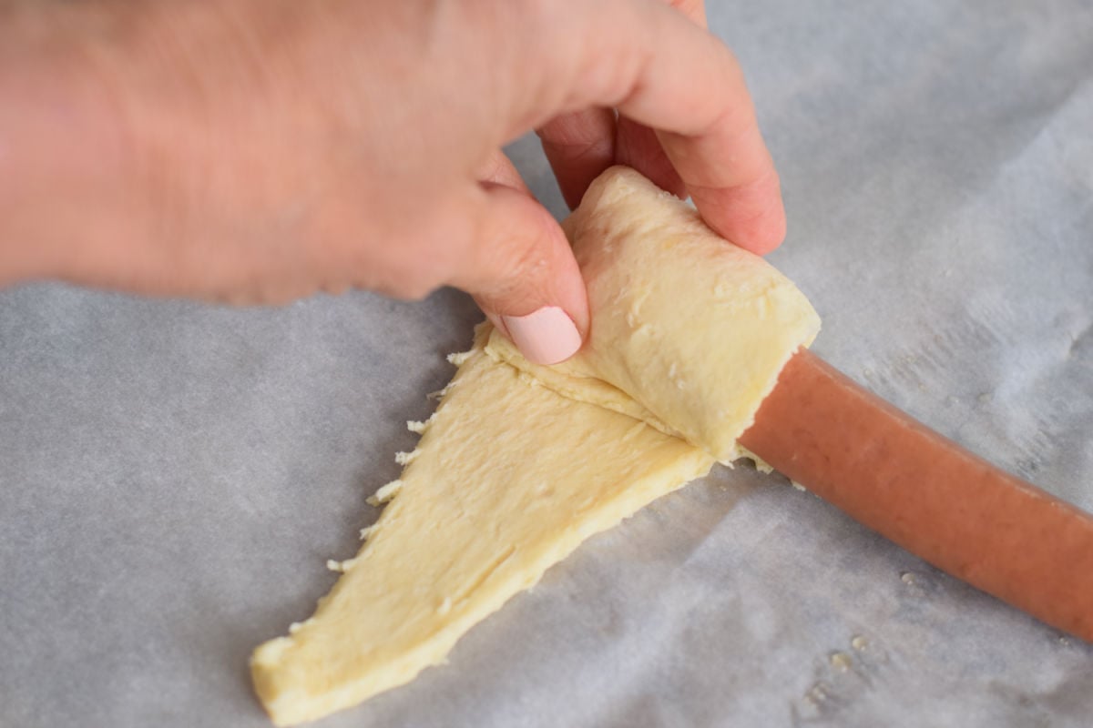 rolling hot dogs in crescent rolls