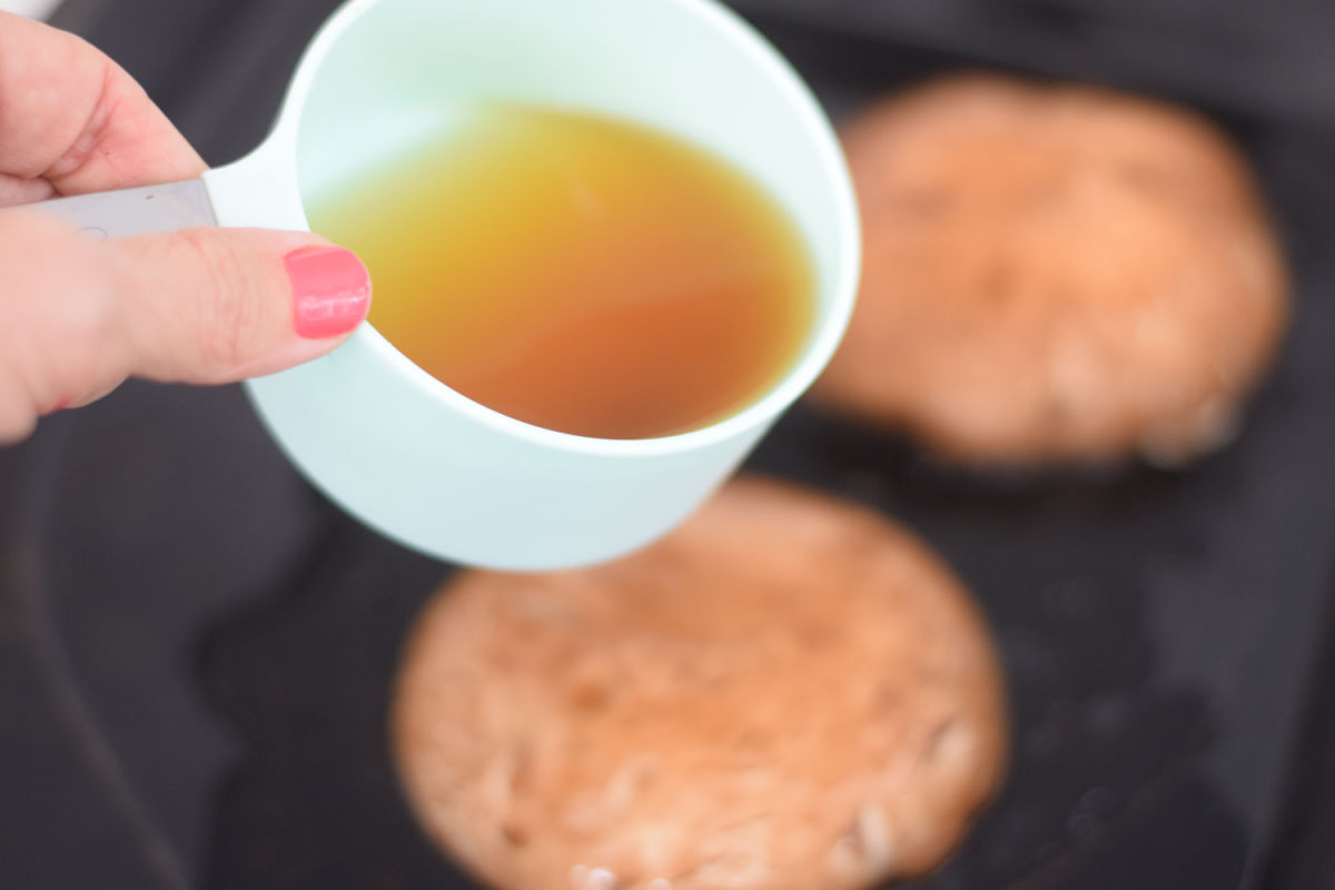 pouring broth over mushrooms