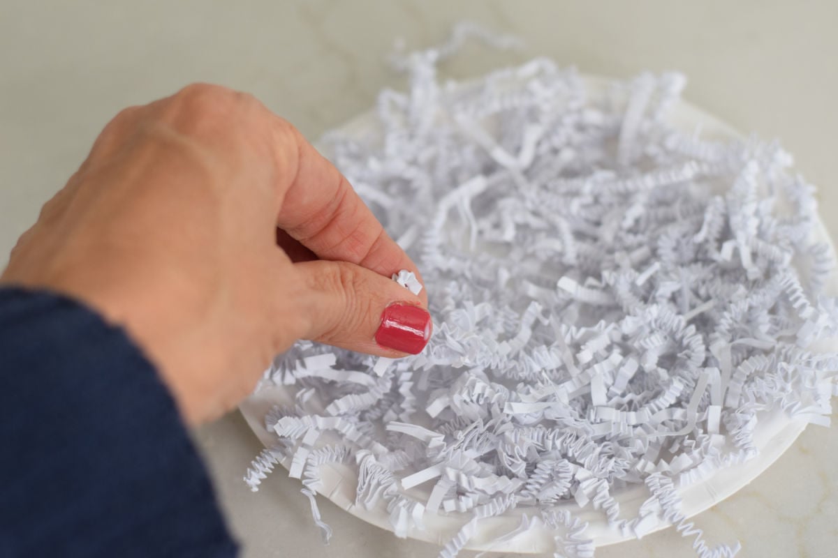making paper plate sheep craft - gluing paper