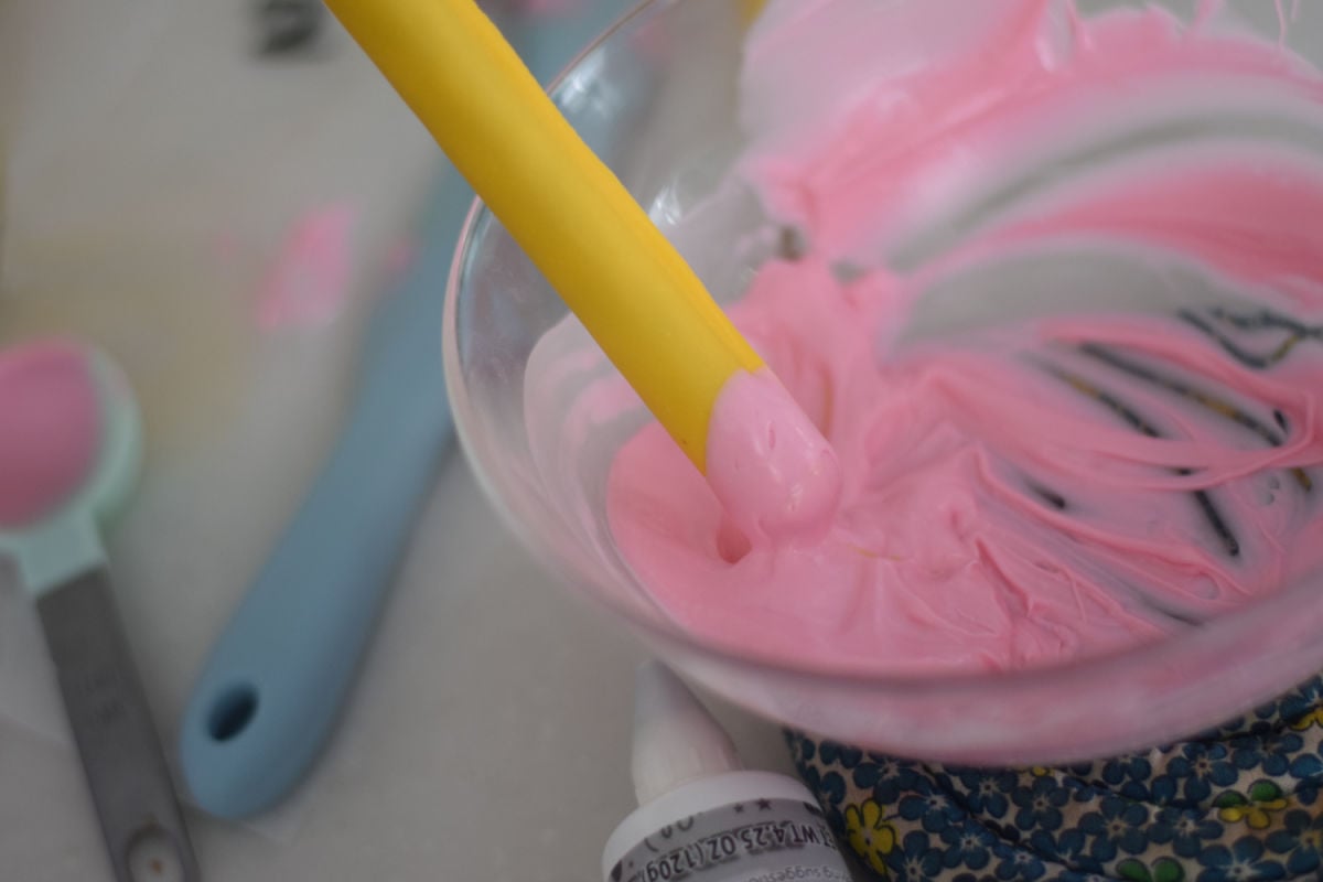 dipping pencil pretzels in pink chocolate 