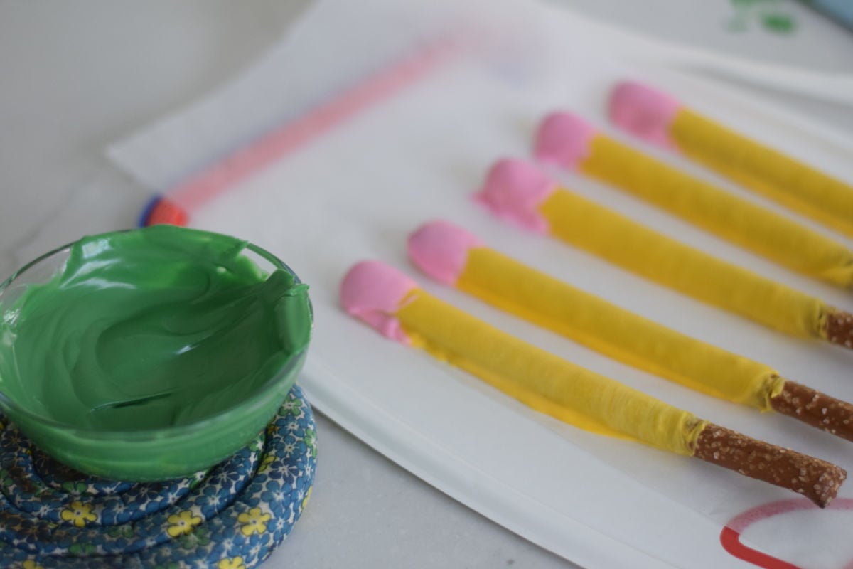 melted green chocolate and pencil pretzels