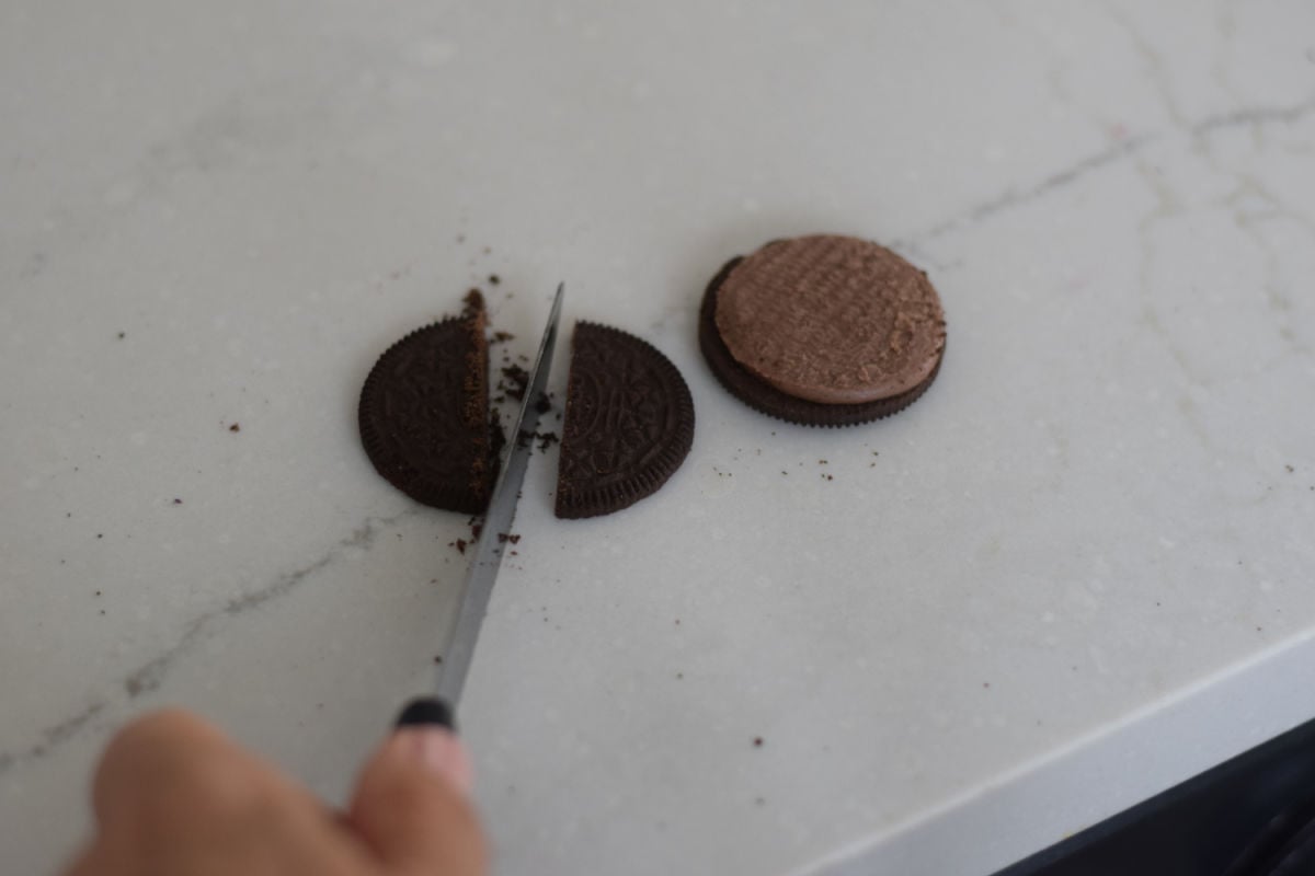 cutting cookie. making bat Oreo cookies 