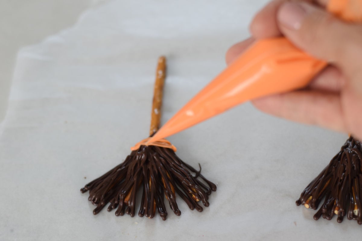 making chocolate pretzel broomsticks 